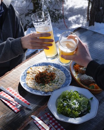 Reitherjoch Alm Personen stoßen mit Bier an